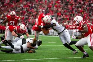 Nebraska Cornhuskers Heinrich Haarberg (10) dives for more yards near the endzone against Purdue Boilermakers Sanoussi Kane (21) and Markevious Brown (1) during a college football game on Saturday, October 28, 2023, in Lincoln, Nebraska. Photo by John S. Peterson.