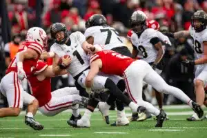 Nebraska Cornhuskers Isaac Gifford (2) and Nebraska Cornhuskers Nick Henrich (3) tackle Purdue Boilermakers Hudson Card (1) in the third quarter during a college football game on Saturday, October 28, 2023, in Lincoln, Nebraska. Photo by John S. Peterson.