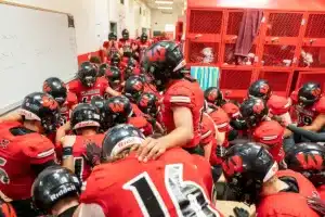 Westside High School warrior recite their team prayer during a game between Lincoln North East and Westside in Omaha, NE on Thursday October 19tth, 2023. Photo by Eric Francis