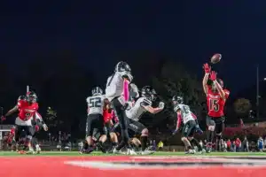 Westside High School Finn Christensen (15) blocks a punt during a game between Lincoln North East and Westside in Omaha, NE on Thursday October 19tth, 2023. Photo by Eric Francis
