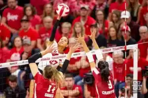 Nebraska Cornhusker Harper Murray (27) spikes the ball against Wisconsin Badgers Anna Smrek (14) and CC Crawford (9) in the fourth set during a college volleyball match on Saturday, October 21, 2023, in Lincoln, Nebraska. Photo by John S. Peterson.