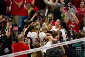 Nebraska Cornhusker celebrate a win over the Wisconsin Badgers in 5 sets during a college volleyball match on Saturday, October 21, 2023, in Lincoln, Nebraska. Photo by John S. Peterson.