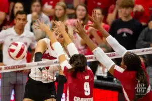 Nebraska Cornhusker Ally Batenhorst (14) spikes the ball around Wisconsin Badgers middle blocker CC Crawford (9) in the fifth set during a college volleyball match on Saturday, October 21, 2023, in Lincoln, Nebraska. Photo by John S. Peterson.