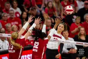 Nebraska Cornhusker Merritt Beason (13) spikes the ball against Wisconsin Badgers outside hitter Sarah Franklin (13) and Wisconsin Badgers middle blocker Carter Booth (52) in the fifith set during a college volleyball match on Saturday, October 21, 2023, in Lincoln, Nebraska. Photo by John S. Peterson.