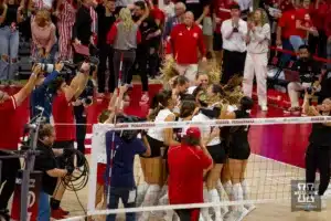 Nebraska Cornhusker celebrate a win over the Wisconsin Badgers in 5 sets during a college volleyball match on Saturday, October 21, 2023, in Lincoln, Nebraska. Photo by John S. Peterson.