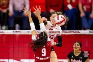 Nebraska Cornhusker Andi Jackson (15) spikes the ball past Wisconsin Badgers middle blocker CC Crawford (9) in the fourth set during a college volleyball match on Saturday, October 21, 2023, in Lincoln, Nebraska. Photo by John S. Peterson.