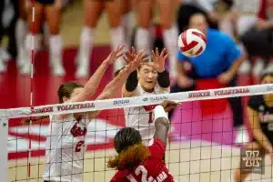 Nebraska Cornhusker Bergen Reilly (2) and Nebraska Cornhusker Andi Jackson (15) try to block Wisconsin Badgers Temi Thomas-Ailara (12) during a college volleyball match on Saturday, October 21, 2023, in Lincoln, Nebraska. Photo by John S. Peterson.