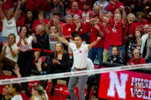 Nebraska Cornhusker assistant coach Jaylen Reyes celebrates a point against the Wisconsin Badgers in the first set during a college volleyball match on Saturday, October 21, 2023, in Lincoln, Nebraska. Photo by John S. Peterson.