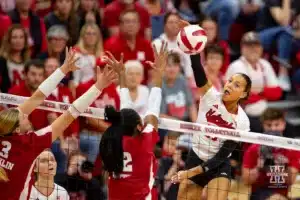 Nebraska Cornhusker Harper Murray (27) spikes the ball against Wisconsin Badgers Sarah Franklin (13) and Carter Booth (52) in the first set during a college volleyball match on Saturday, October 21, 2023, in Lincoln, Nebraska. Photo by John S. Peterson.