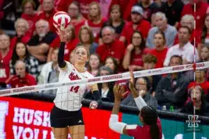 Nebraska Cornhusker Ally Batenhorst (14) tips the ball over the net against the Wisconsin Badgers in the first set during a college volleyball match on Saturday, October 21, 2023, in Lincoln, Nebraska. Photo by John S. Peterson.