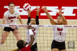 Nebraska Cornhusker Harper Murray (27) and Nebraska Cornhusker Bekka Allick (5) jump to block Wisconsin Badgers Temi Thomas-Ailara (12) in the second set during a college volleyball match on Saturday, October 21, 2023, in Lincoln, Nebraska. Photo by John S. Peterson.
