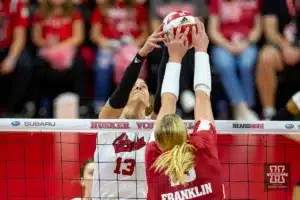 Nebraska Cornhusker Merritt Beason (13) and Wisconsin Badgers outside hitter Sarah Franklin (13) battle at the net in the second set during a college volleyball match on Saturday, October 21, 2023, in Lincoln, Nebraska. Photo by John S. Peterson.