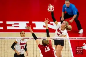 Nebraska Cornhusker Ally Batenhorst (14) spikes the ball against Wisconsin Badgers Anna Smrek (14) in the second set during a college volleyball match on Saturday, October 21, 2023, in Lincoln, Nebraska. Photo by John S. Peterson.