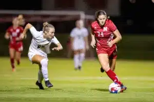 Nebraska Cornhuskers Briley Hill (74) drives around Purdue Boilermakers Sydney Boudreau (25) in the second half during a college soccer game on Thursday, October 19, 2023, in Lincoln, Nebraska. Photo by John S. Peterson.