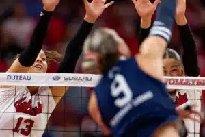 Nebraska Cornhusker Merritt Beason (13) and Nebraska Cornhusker Andi Jackson (15) try to block a spike from Penn State Nittany Lions Jess Mruzik (9) in the first set during a college volleyball match on Saturday, October 14, 2023, in Lincoln, Nebraska. Photo by John S. Peterson.