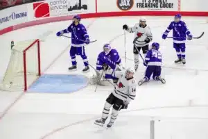 Omaha Mavericks forward Jesse Lansdell (14) celebrates a goal in the third period against the Niagara Purple Eagles during a college hockey match on Friday, October 13, 2023, in Omaha, Nebraska. Photo by John S. Peterson.