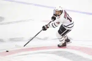 Omaha Mavericks forward Ty Mueller (19) on the attack against against the Niagara Purple Eagles in the third period during a college hockey match on Friday, October 13, 2023, in Omaha, Nebraska. Photo by John S. Peterson.