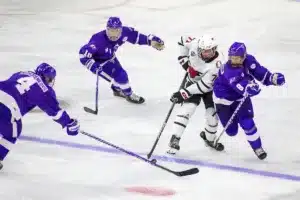 Omaha Mavericks forward Tanner Ludtke (71) battles against Niagara Purple Eagles forward Luke Mylymok (8) for the puck in the third period during a college hockey match on Friday, October 13, 2023, in Omaha, Nebraska. Photo by John S. Peterson.