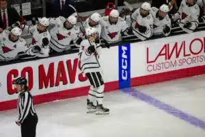 Omaha Mavericks forward Tanner Ludtke (71) skates down the line of teammates after the first goal against the Niagara Purple Eagles during a college hockey match on Friday, October 13, 2023, in Omaha, Nebraska. Photo by John S. Peterson.