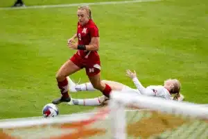 Nebraska Cornhuskers Eleanor Dale (9) beats out Maryland Terrapins defender Katie Coyle (9) in the second half during a college soccer match Thursday, October 12, 2023, in Lincoln, Neb. Photo by John S. Peterson.