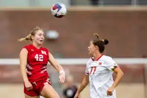 Nebraska Cornhuskers Sarah Weber (42) heads the ball against Maryland Terrapins defender Caroline Koutsos (77) in the first half during a college soccer match Thursday, October 12, 2023, in Lincoln, Neb. Photo by John S. Peterson.