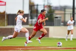 Nebraska Cornhuskers Florence Belzile (10) dribbles the ball against Maryland Terrapins defender Katie Coyle (9) in the first half during a college soccer match Thursday, October 12, 2023, in Lincoln, Neb. Photo by John S. Peterson.