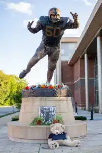 Flowers left at the statue of Dick Butkus after his death the day before the game between Nebraska and Illinois during a college football game in Lincoln, Nebraska, Friday, October 6, 2023. Photo by John Peterson.