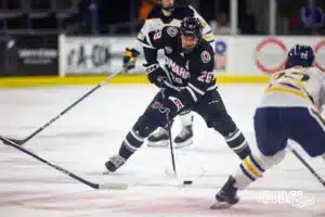 Omaha Maverick forward Jack Randl (28) works his way down the ice against the Augustana Vikings during the hockey match on Saturday, November 25, 2023, in Sioux Falls, SD. Photo by John S. Peterson.