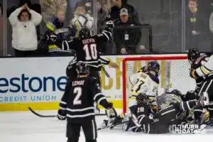 Omaha Maverick defenseman Jacob Guevin (10) celebrates his goal against the Augustana Vikings in the second period during the hockey match on Saturday, November 25, 2023, in Sioux Falls, SD. Photo by John S. Peterson.