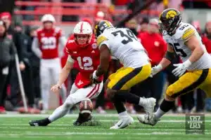 Nebraska Cornhusker quarterback Chubba Purdy (12) fumbles the football against Iowa Hawkeye linebacker Jay Higgins (34) in the fourth quarter during the football game on Thursday, November 24, 2023, in Lincoln, Neb. Photo by John S. Peterson.