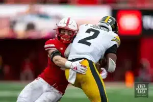 Nebraska Cornhusker defensive back Isaac Gifford (2) tackles Iowa Hawkeye running back Kaleb Johnson (2) in the second quarter during the football game on Thursday, November 24, 2023, in Lincoln, Neb. Photo by John S. Peterson.