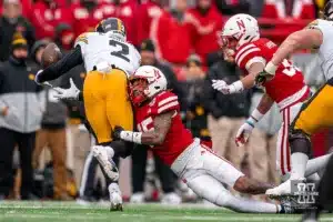 Nebraska Cornhuskers defensive back Tamon Lynum (15) wraps up Iowa Hawkeyes running back Kaleb Johnson (2) during a game in Lincoln, NE November 24th 2023. Photo by Eric Francis