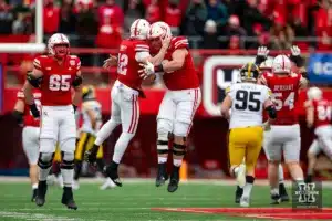 Nebraska Cornhusker quarterback Chubba Purdy (12) celebrates a touchdown pass with offensive lineman Ben Scott (66) in the second quarter against the Iowa Hawkeyes  during the football game on Thursday, November 24, 2023, in Lincoln, Neb. Photo by John S. Peterson.