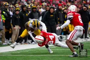 Nebraska Cornhusker defensive back Marques Buford Jr. (24) tackles Iowa Hawkeye running back Leshon Williams (4) in the second quarter during the football game on Thursday, November 24, 2023, in Lincoln, Neb. Photo by John S. Peterson.