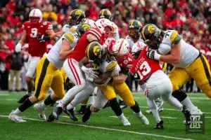 Nebraska Cornhusker linebacker Luke Reimer (4) tackles Iowa Hawkeye running back Jaziun Patterson (9) in the first quarter during the football game on Thursday, November 24, 2023, in Lincoln, Neb. Photo by John S. Peterson.