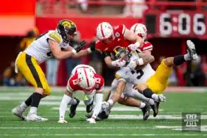 Nebraska Cornhusker defensive back Isaac Gifford (2) tackles Iowa Hawkeye wide receiver Kaleb Brown (3) in the first quarter during the football game on Thursday, November 24, 2023, in Lincoln, Neb. Photo by John S. Peterson.