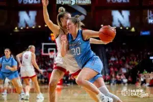 Creighton Bluejay forward Morgan Maly (30) drives to the basket against Nebraska Cornhusker forward Natalie Potts (22) in the fourth quarter during the basketball game on Sunday, November 19, 2023, in Lincoln, Nebraska. Photo by John S. Peterson.