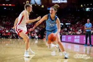 Creighton Bluejay forward Morgan Maly (30) drives to the basket against Nebraska Cornhusker forward Natalie Potts (22) during the basketball game on Sunday, November 19, 2023, in Lincoln, Nebraska. Photo by John S. Peterson.