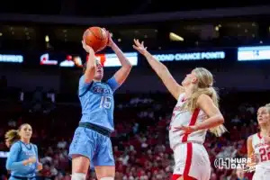 Creighton Bluejay guard Lauren Jensen (15) makes a jump shot against Nebraska Cornhusker forward Jessica Petrie (12) in the second quarter during the basketball game on Sunday, November 19, 2023, in Lincoln, Nebraska. Photo by John S. Peterson.