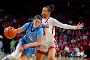 Creighton Bluejay guard Lauren Jensen (15) dribbles the ball against Nebraska Cornhusker guard Darian White (0) in the second quarter during the basketball game on Sunday, November 19, 2023, in Lincoln, Nebraska. Photo by John S. Peterson.