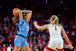 Creighton Bluejay forward Emma Ronsiek (31) makes a pass against Nebraska Cornhusker guard Jaz Shelley (1) during the basketball game on Sunday, November 19, 2023, in Lincoln, Nebraska. Photo by John S. Peterson.