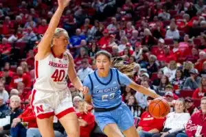 Creighton Bluejay guard Brittany Harshaw (23) drives to the basket against Nebraska Cornhusker center Alexis Markowski (40) in the second quarter during the basketball game on Sunday, November 19, 2023, in Lincoln, Nebraska. Photo by John S. Peterson.