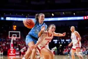 Nebraska Cornhusker guard Logan Nissley (2) dive in front of Creighton Bluejay forward Emma Ronsiek (31) in the second quarter during the basketball game on Sunday, November 19, 2023, in Lincoln, Nebraska. Photo by John S. Peterson.