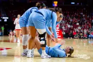 Creighton Bluejay guard Molly Mogensen (21) gets some help up after being knocked down against the Nebraska Cornhuskers in the first quarter during the basketball game on Sunday, November 19, 2023, in Lincoln, Nebraska. Photo by John S. Peterson.