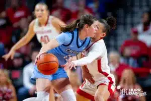 Nebraska Cornhusker guard Darian White (0) reaches for the balla against Creighton Bluejay guard Lauren Jensen (15) in the first qaurter during the basketball game on Sunday, November 19, 2023, in Lincoln, Nebraska. Photo by John S. Peterson.