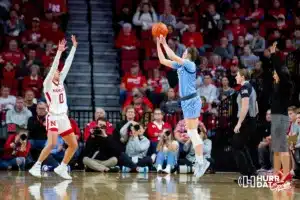 Creighton Bluejay guard Lauren Jensen (15) makes a three point shot against Nebraska Cornhusker guard Darian White (0) in the first quarter during the basketball game on Sunday, November 19, 2023, in Lincoln, Nebraska. Photo by John S. Peterson.