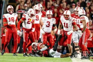 Nebraska Cornhuskers defense stands over Wisconsin Badgers running back Jackson Acker