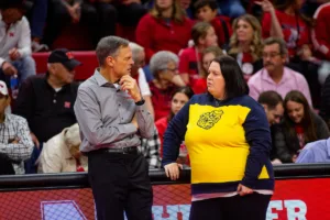 Nebraska Cornhusker head coach John Cook and Michigan Wolverine head coach Erin Virtue talk before the volleyball match on Friday, November 17, 2023, in Lincoln, Nebraska. Photo by John S. Peterson.