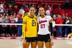 Sisters Nebraska Cornhusker Harper Murray (27) and Michigan Wolverine Kendall Murray (27) pose for a photo after the volleyball match on Friday, November 17, 2023, in Lincoln, Nebraska. Photo by John S. Peterson.