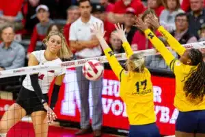 Nebraska Cornhusker Ally Batenhorst (14) spikes the ball past Michigan Wolverine Jacque Boney (17) in the third set during the volleyball match on Friday, November 17, 2023, in Lincoln, Nebraska. Photo by John S. Peterson.